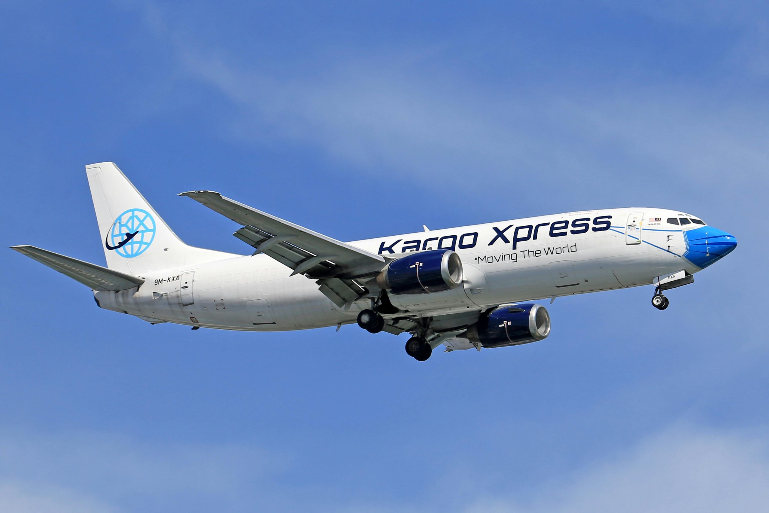 Cargo airplane in flight, showcasing a clear blue sky backdrop, emphasizes aviation and logistics.